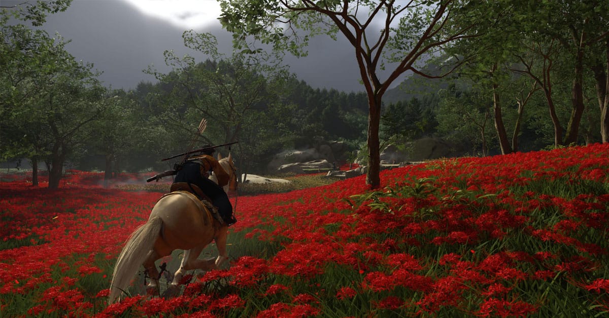 Ghost of Yotei Review - Atsu riding through a field of red flowers
